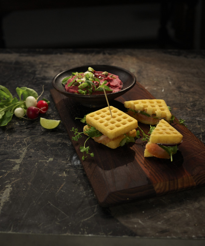 Potato waffle sandwich with smoked salmon and beetroot potato mash